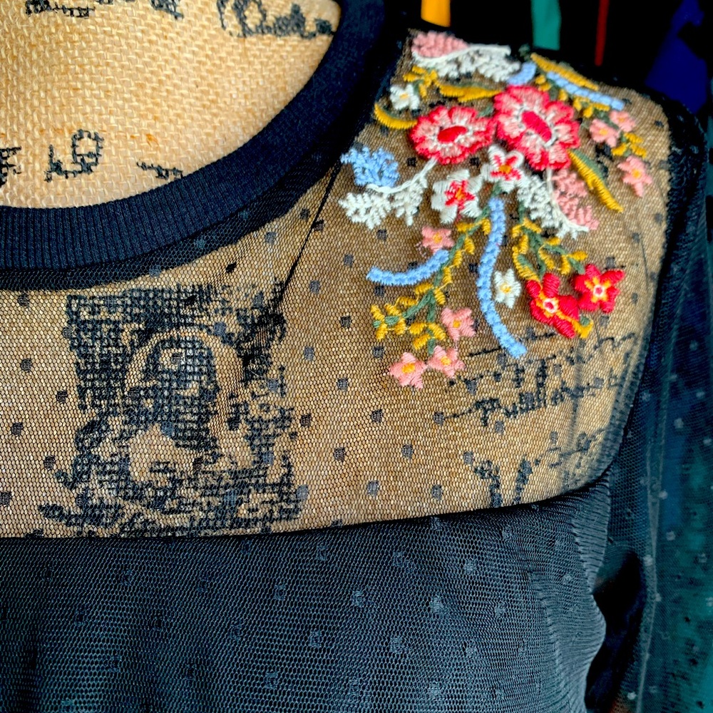 Chiffon black lace top with floral appliqué.
